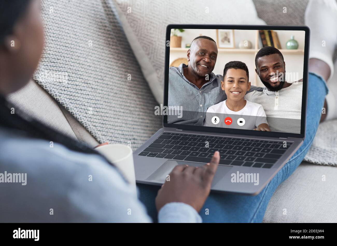 Black Family Having Video Call Online Using Laptop At Home Stock Photo