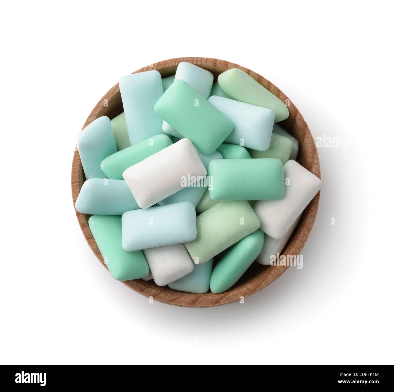 Top view of wooden bowl with mint chewing gum pieces isolated on a white Stock Photo