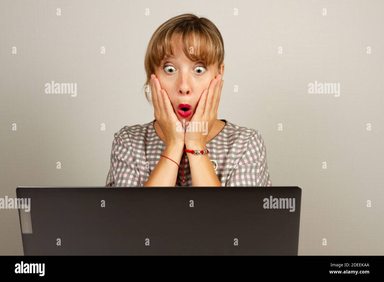 beautiful young girl was very surprised working in the office at the computer Stock Photo