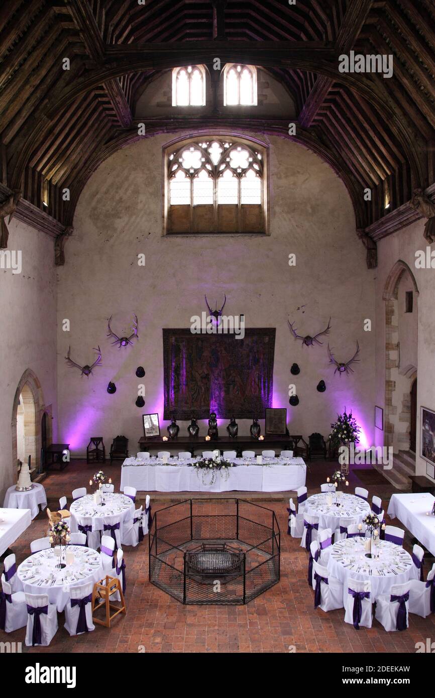 The late medieval 14th century Baron’s Hall or Great Hall with open hearth at Penshurst Place, decorated for a wedding reception Stock Photo