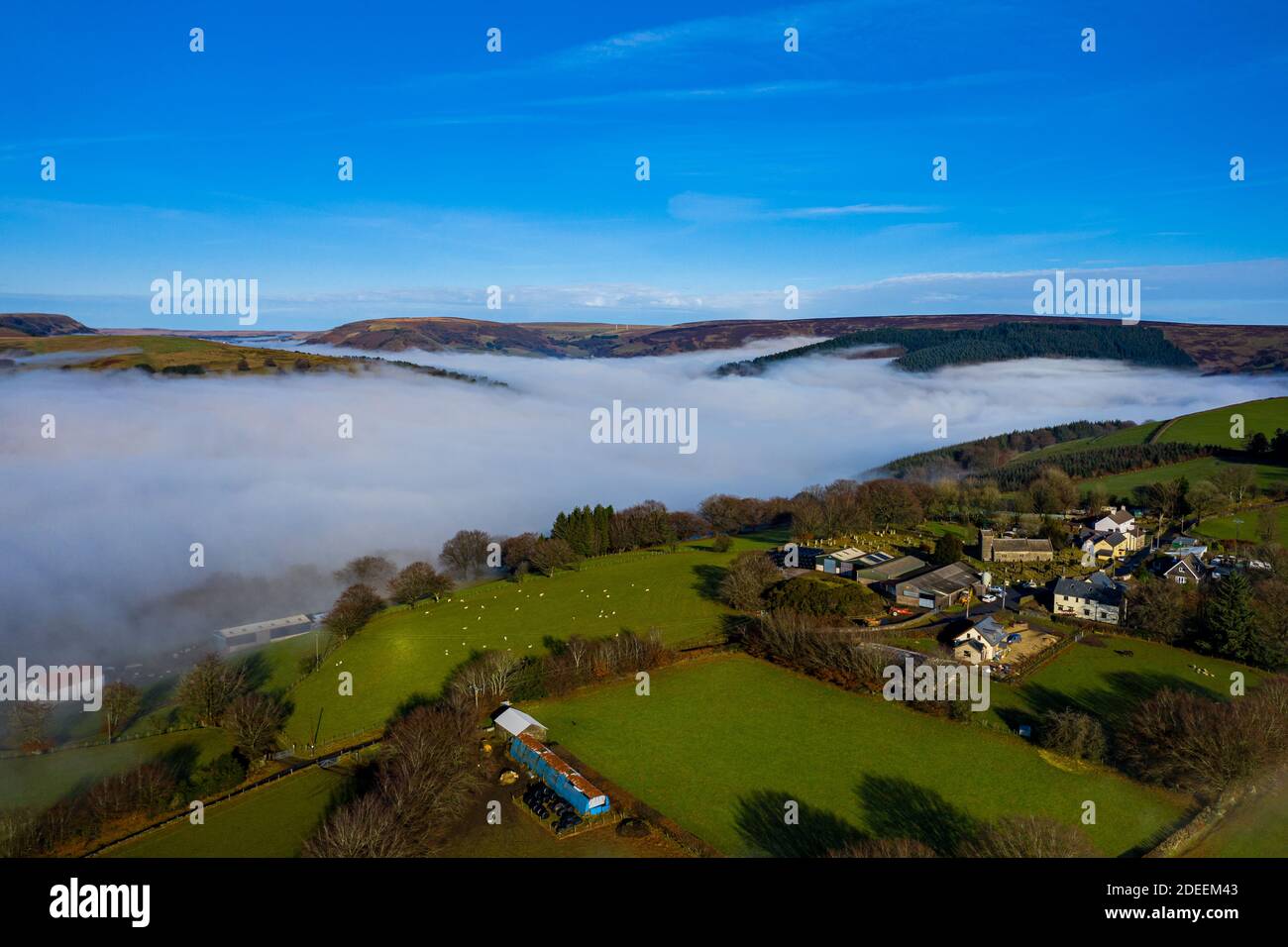 Beautiful morning of drone footage overlooking welsh sceneray with fog sheet covering the lower valleys in south wales uk. Stock Photo
