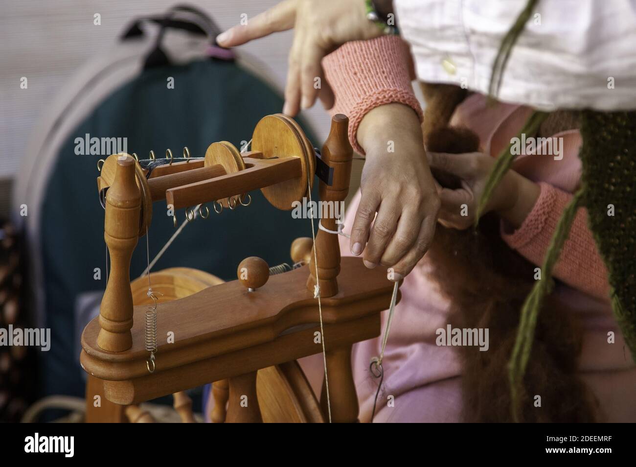 Spinner working in sewing with wool, artisan production, industry Stock