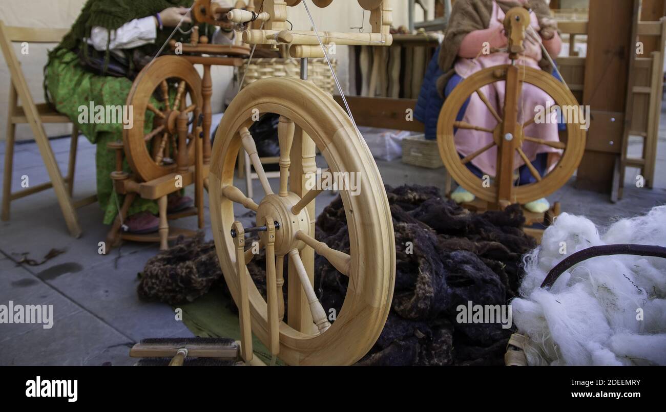 Spinner working in sewing with wool, artisan production, industry Stock