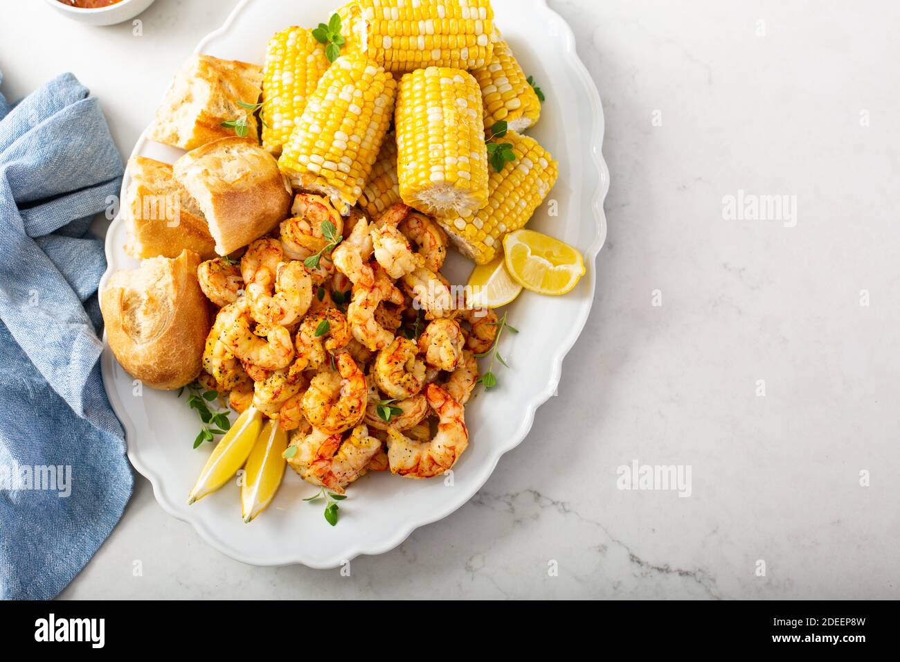 Fried shrimp and corn on the cob Stock Photo
