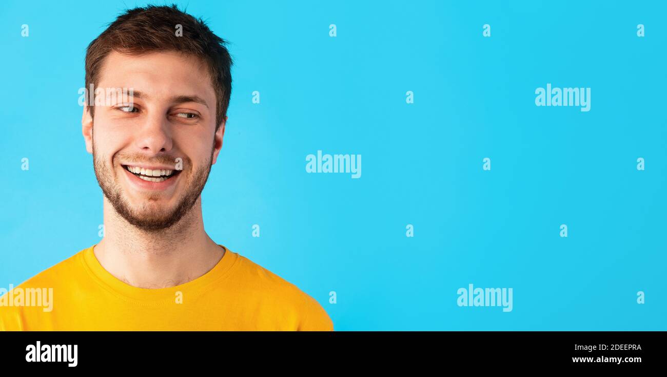 Smiling confident man looking at copy space on blue background Stock Photo