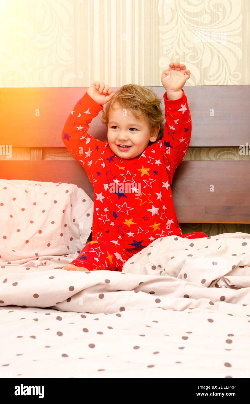 little boy in pajamas on the bed Stock Photo Alamy