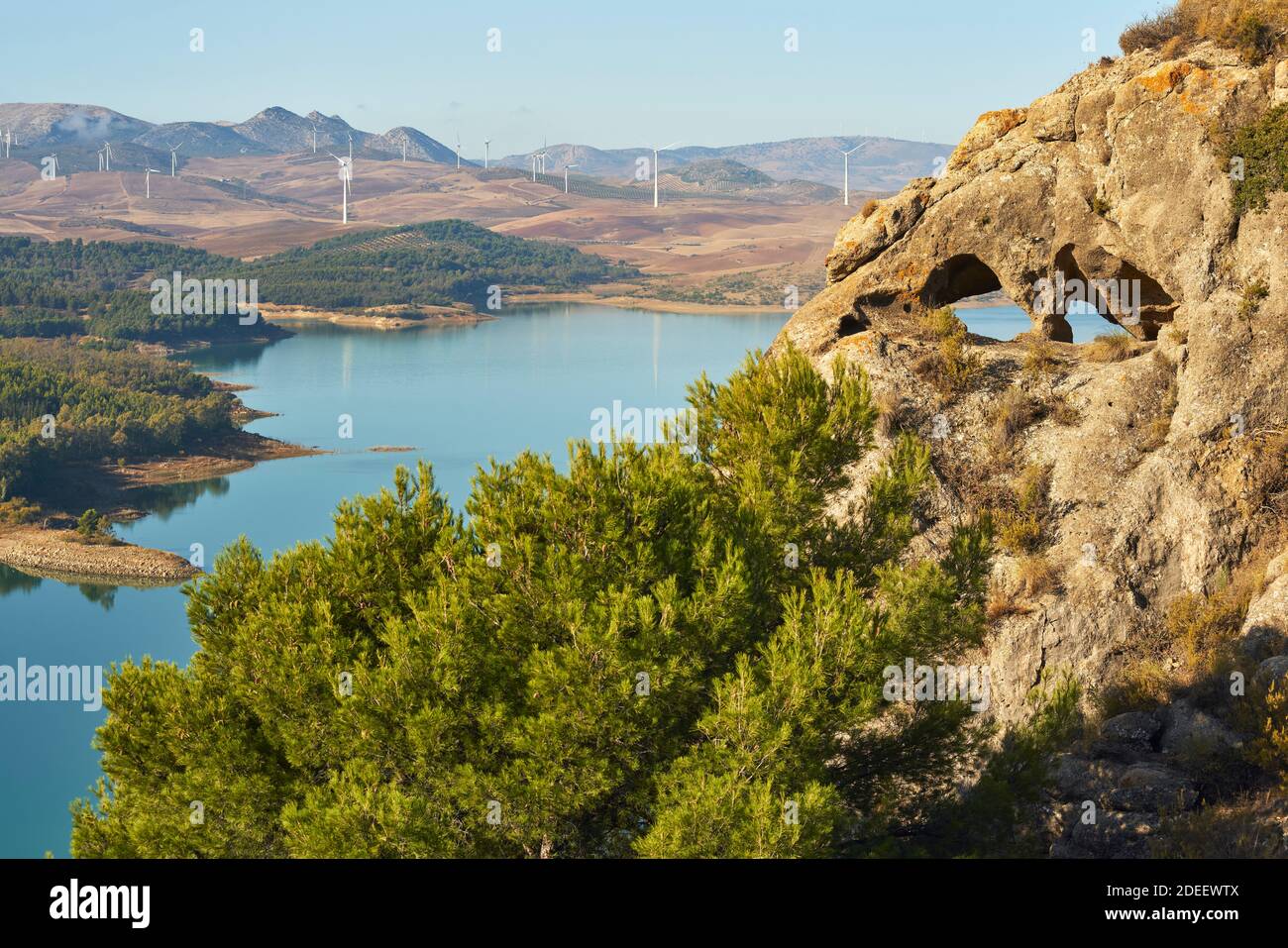 Guadalteba reservoir in the province of Malaga with a wind farm in the background. Andalusia, Spain Stock Photo