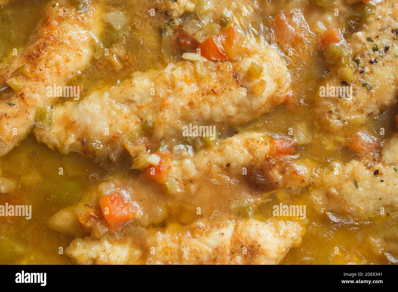 Overhead view of whiskey chicken fillet with garlic and cheese sauce and vegetables. Mediterranean healthy food. Stock Photo
