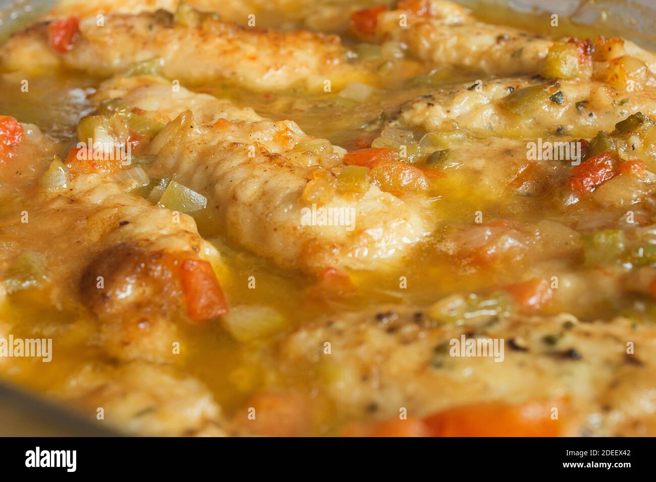 A whiskey chicken fillet with garlic and cheese sauce and vegetables. Mediterranean healthy food. Stock Photo
