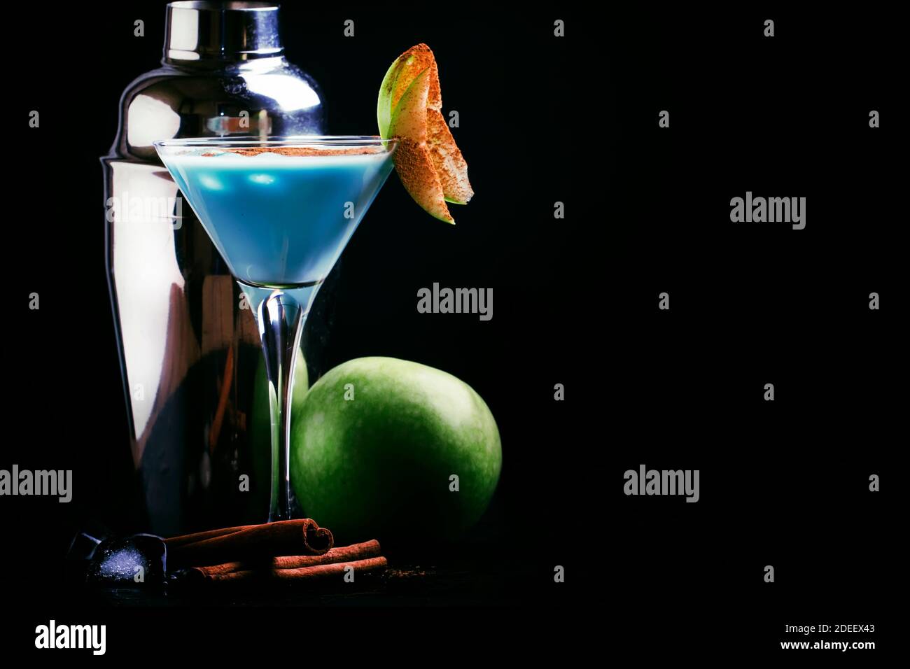 Blue cocktails with liqueur, cream and green apple, bar tools on a