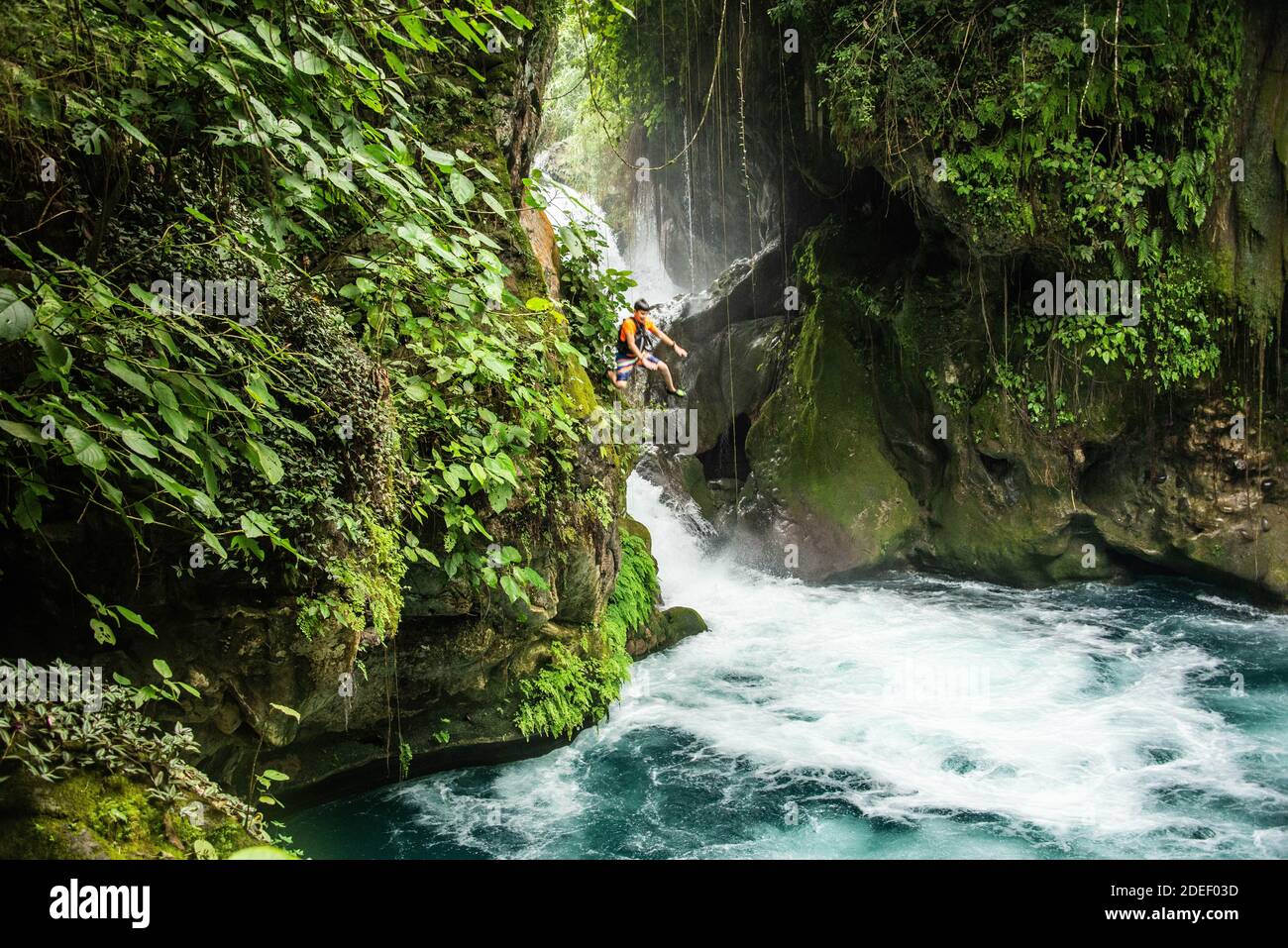 Jumping at The beautiful Puente de Dios waterfall and cenote, Tamasopo, San Luis Potosi, Mexico Stock Photo