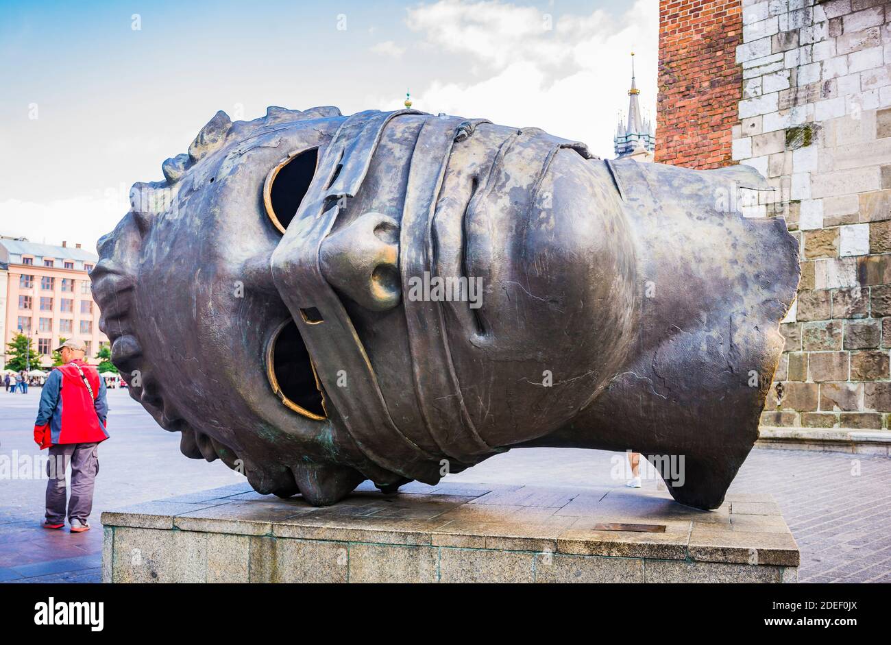 The bronze sculpture 'The Head', also know as 'The Eros Bendato', by the  Polish sculptor Igor Mitoraj, in Krakow is in the western corner of the  Main Stock Photo - Alamy