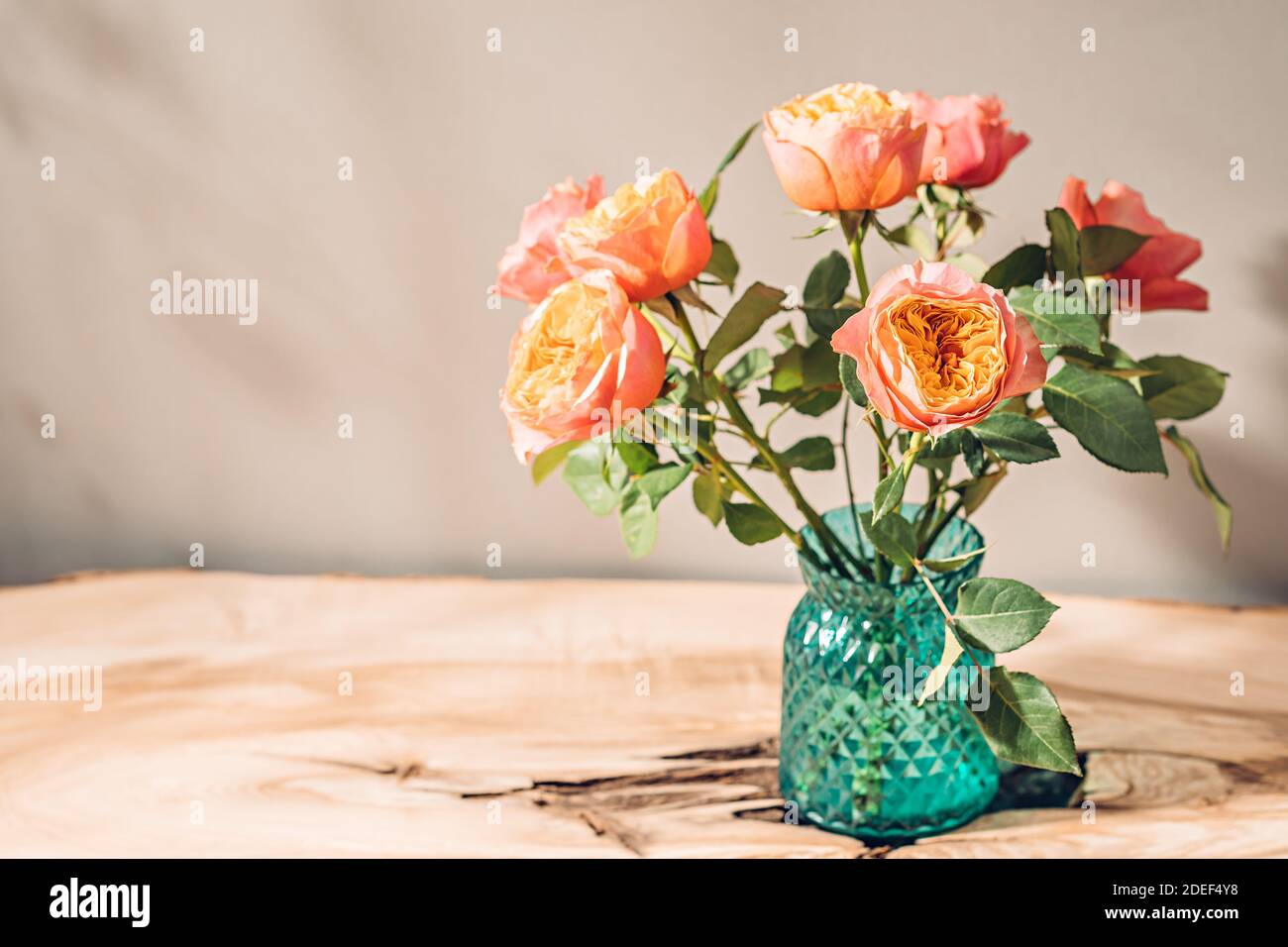 Rustic bouquet of roses in vase on table in sunlight Stock Photo Alamy