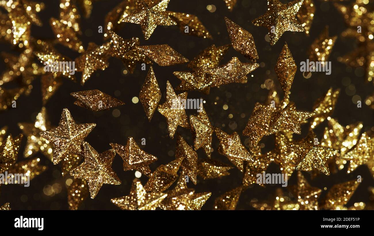 Gold stars flying up in the air, abstract background. Stock Photo