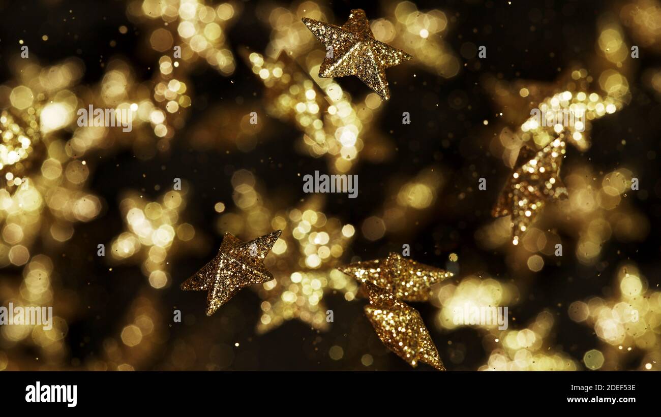 Gold stars flying up in the air, abstract background. Stock Photo