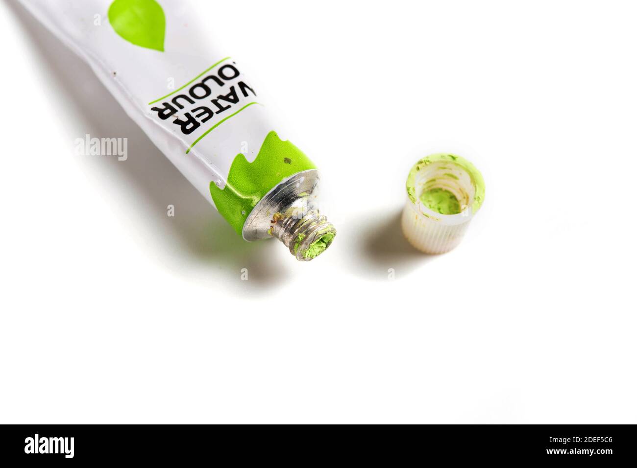 Dried green watercolor paint in a tube isolated on white background