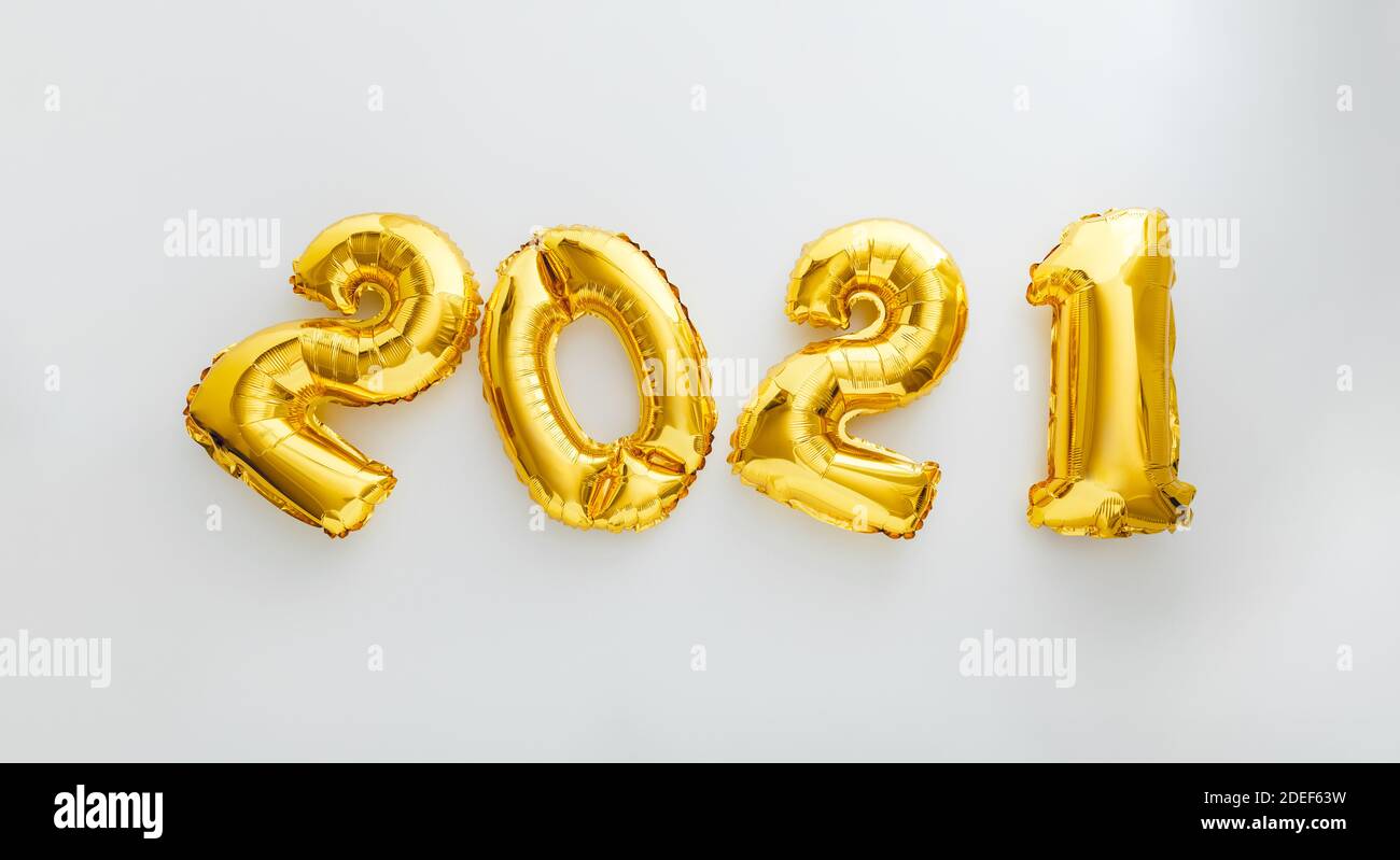 2021 balloon text on white background. Happy New year eve invitation with Christmas gold foil balloons 2021. Flat lay long web banner Stock Photo
