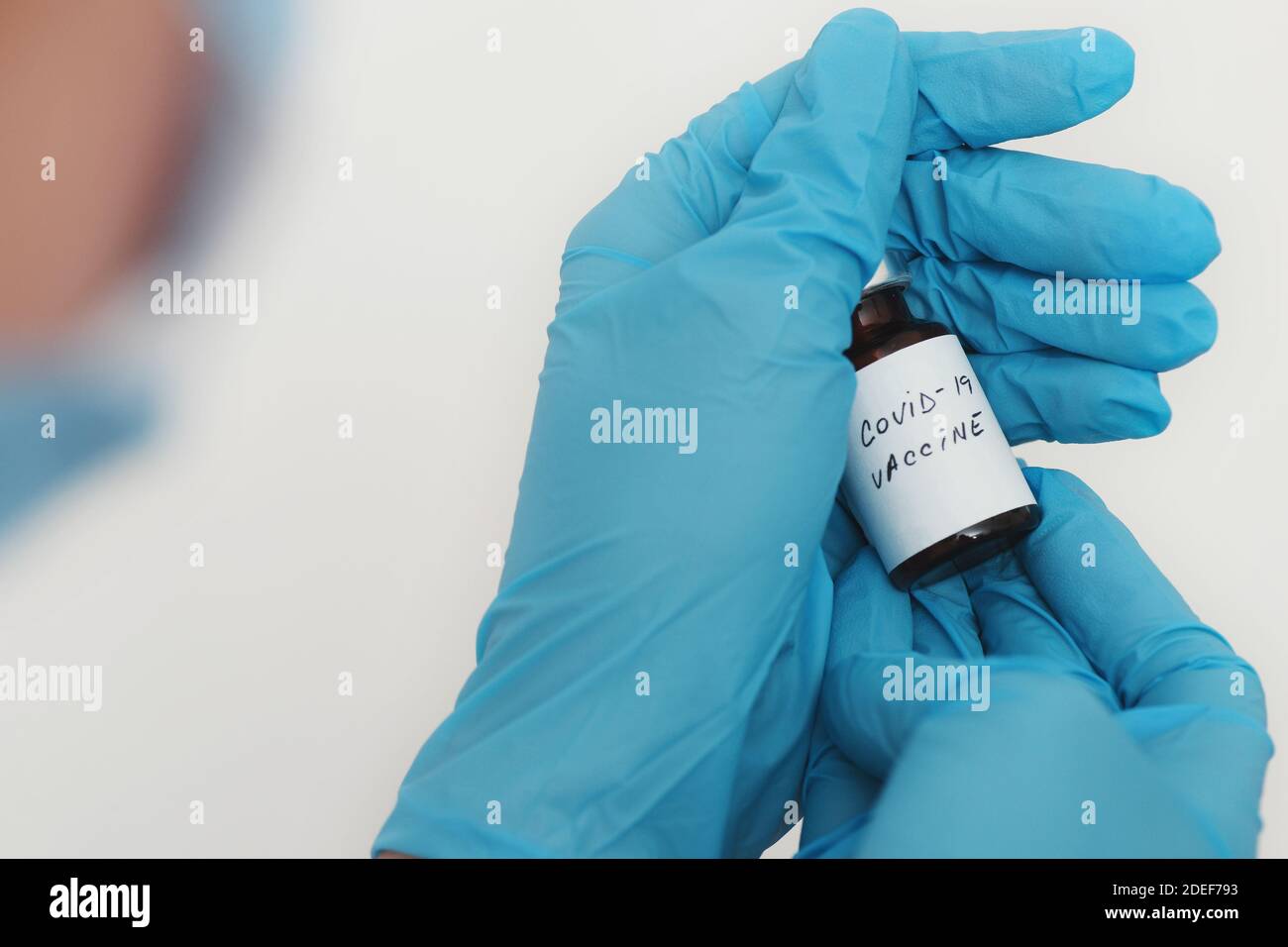 Female doctor holding in her hand coronavirus vaccine - covid-19 health concept Stock Photo