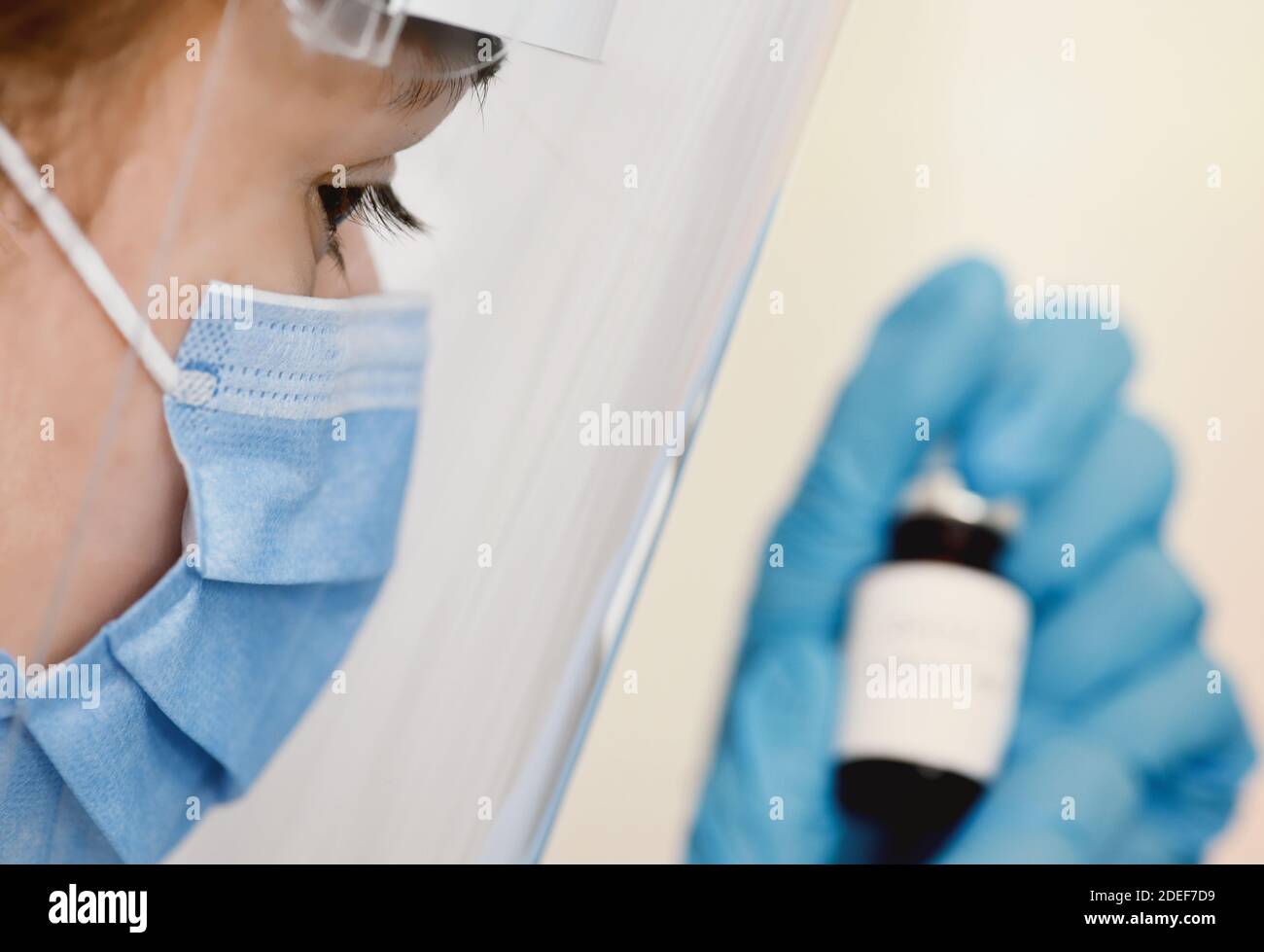 Female doctor holding in her hand coronavirus vaccine - covid-19 health concept Stock Photo