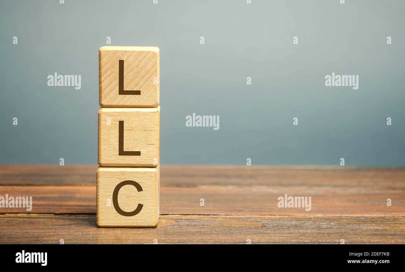 Wooden blocks with LLC - Limited Liability Company. Business concept. Hybrid companies that combine the characteristics of a corporation and a partner Stock Photo