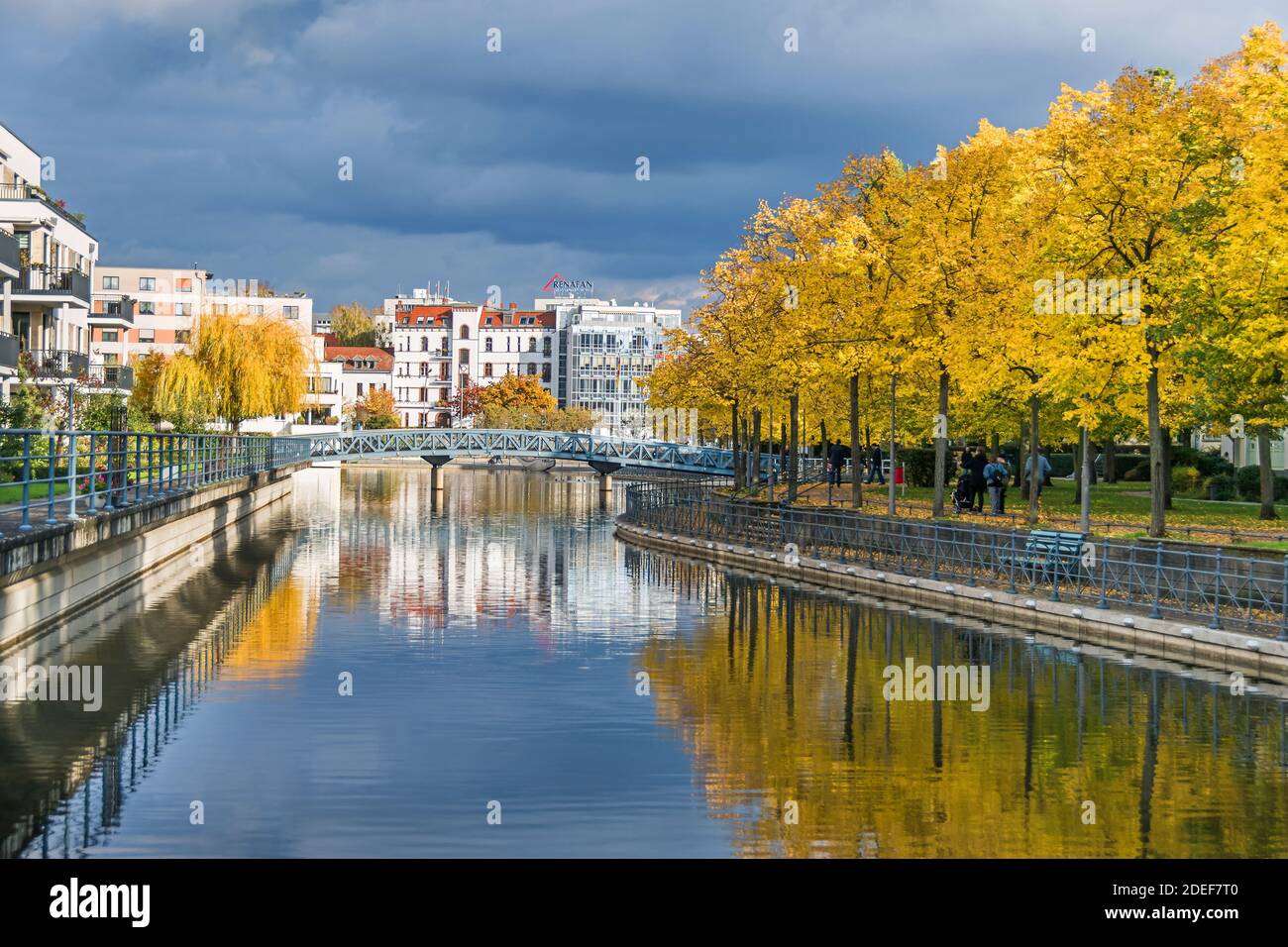 Berlin, Germany - October 24, 2020:  Harbor basin Tegeler Hafen with old and modern buildings,  residential units, footbridge and autumn coloured tree Stock Photo