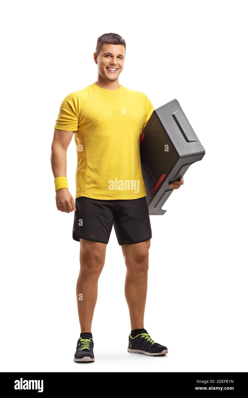 Full length portrait of a young man holding an aerobic stepper and smiling isolataed on white background Stock Photo