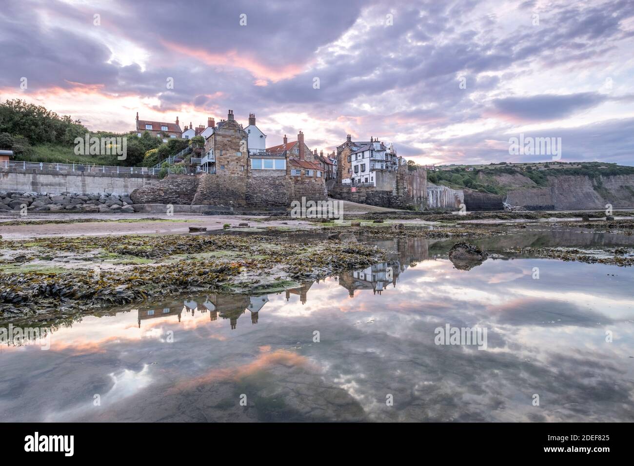 Sunset over the small fishing village of Robin Hoods Bay, North Yorkshire Coast Stock Photo