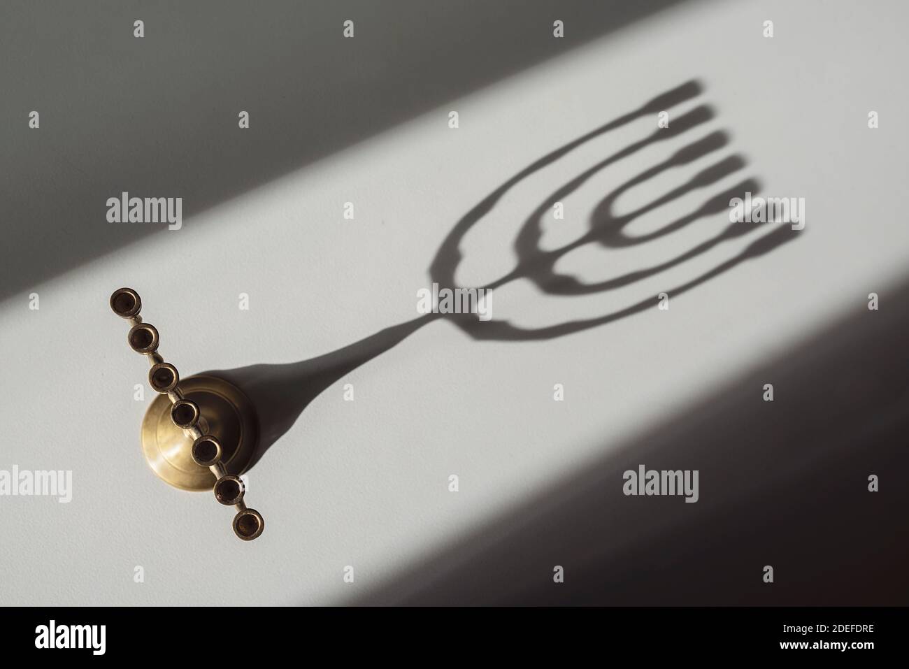 View from above of a Jewish candlestick and its shadow Stock Photo