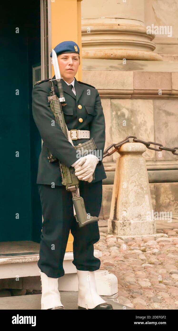 Female soldier stands guard outside the Royal Palace in the Stortorget, Gamla Stan square, Stockholm, Sweden Stock Photo