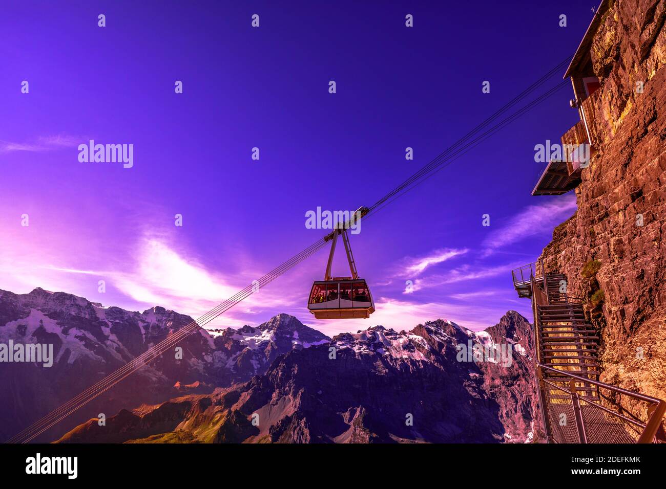 Cable car at Birg to Schilthorn summit above cliffs, rocky mountains