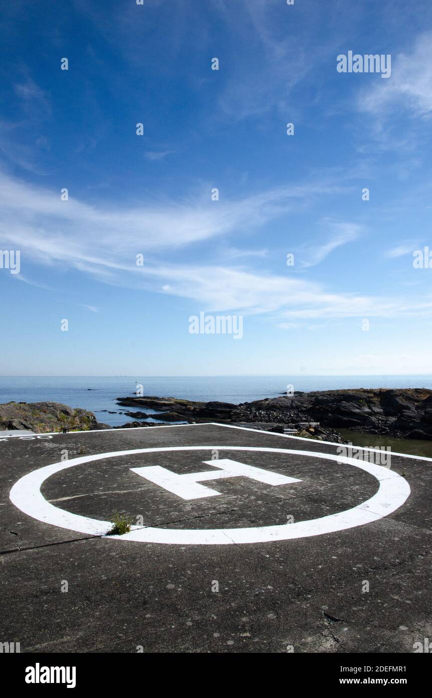 Helicopter landing pad next to the ocean Stock Photo