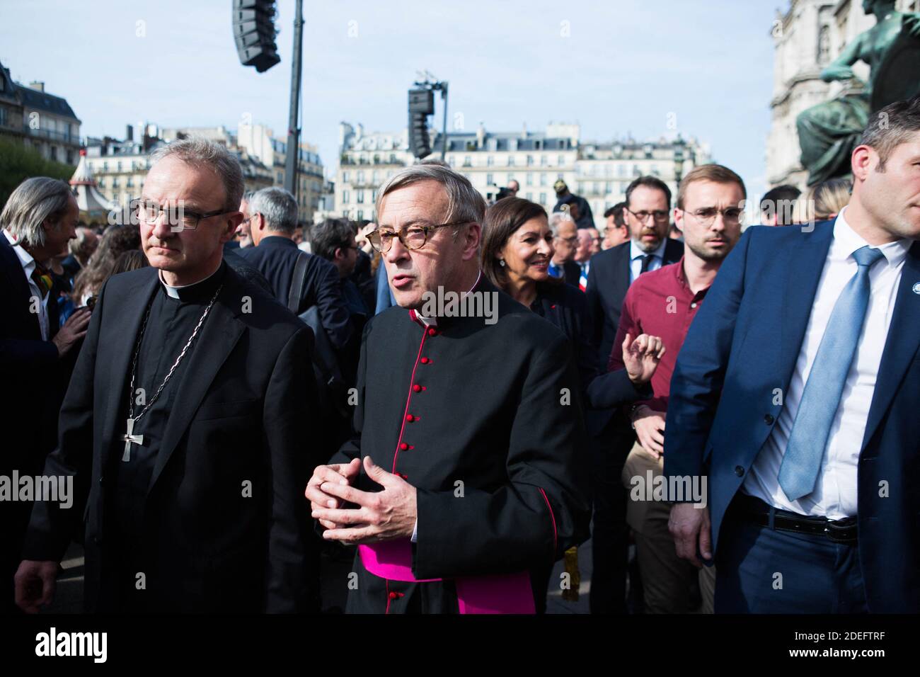 Notre Dame cathedral rector Jean-Marc Chauvet French Interior Minister Christophe Castaner, Paris prefect Didier Lallement, Paris mayor Anne Hidalgo, and other officials walk by Notre Dame cathedral on April 18, 2019 in Paris. France paid a daylong tribute on April 18, 2019 to the Paris firefighters who saved Notre Dame Cathedral from collapse, while construction workers rushed to secure an area above one of the church's famed rose-shaped windows and other vulnerable sections of the fire-damaged landmark. Photo by Raphael Lafargue/ABACAPRESS.COM Stock Photo