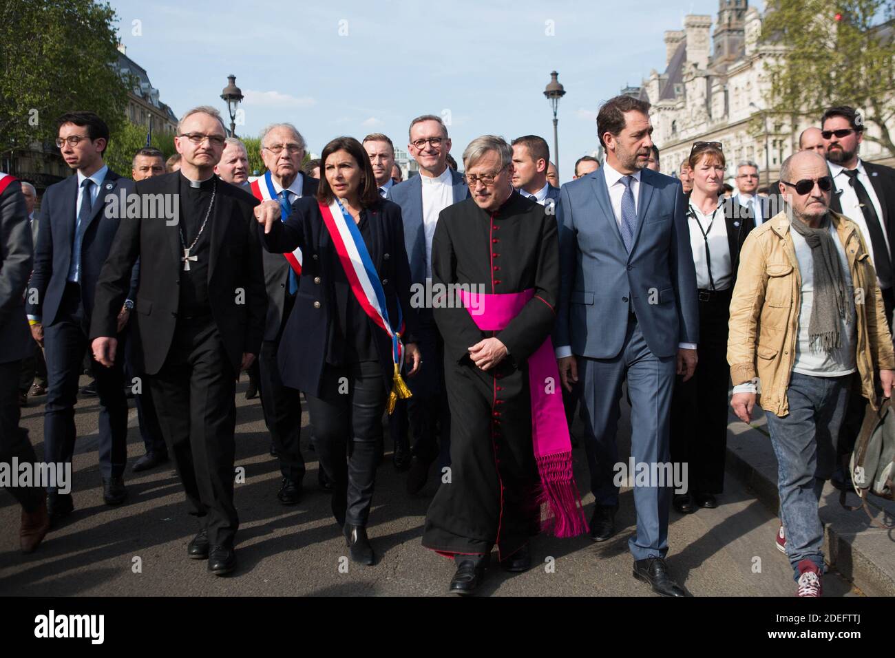 French Interior Minister Christophe Castaner (C), Notre Dame cathedral rector Jean-Marc Chauvet (2L), Paris mayor Anne Hidalgo (L), Paris prefect Didier Lallement (3R) and other officials walk to Notre Dame cathedral on April 18, 2019 in Paris. France paid a daylong tribute on April 18, 2019 to the Paris firefighters who saved Notre Dame Cathedral from collapse, while construction workers rushed to secure an area above one of the church's famed rose-shaped windows and other vulnerable sections of the fire-damaged landmark. Photo by Raphael Lafargue/ABACAPRESS.COM Stock Photo