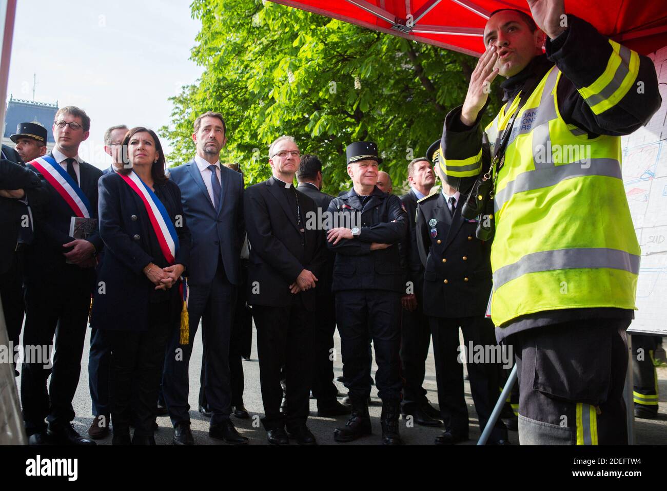 Jean-Claude Gallet General of the fire fighters of paris, Jean-Marc Chauve, French Interior Minister Christophe Castaner, Paris prefect Didier Lallement, Paris mayor Anne Hidalgo, and other officials walk by Notre Dame cathedral on April 18, 2019 in Paris. France paid a daylong tribute on April 18, 2019 to the Paris firefighters who saved Notre Dame Cathedral from collapse, while construction workers rushed to secure an area above one of the church's famed rose-shaped windows and other vulnerable sections of the fire-damaged landmark. Photo by Raphael Lafargue/ABACAPRESS.COM Stock Photo