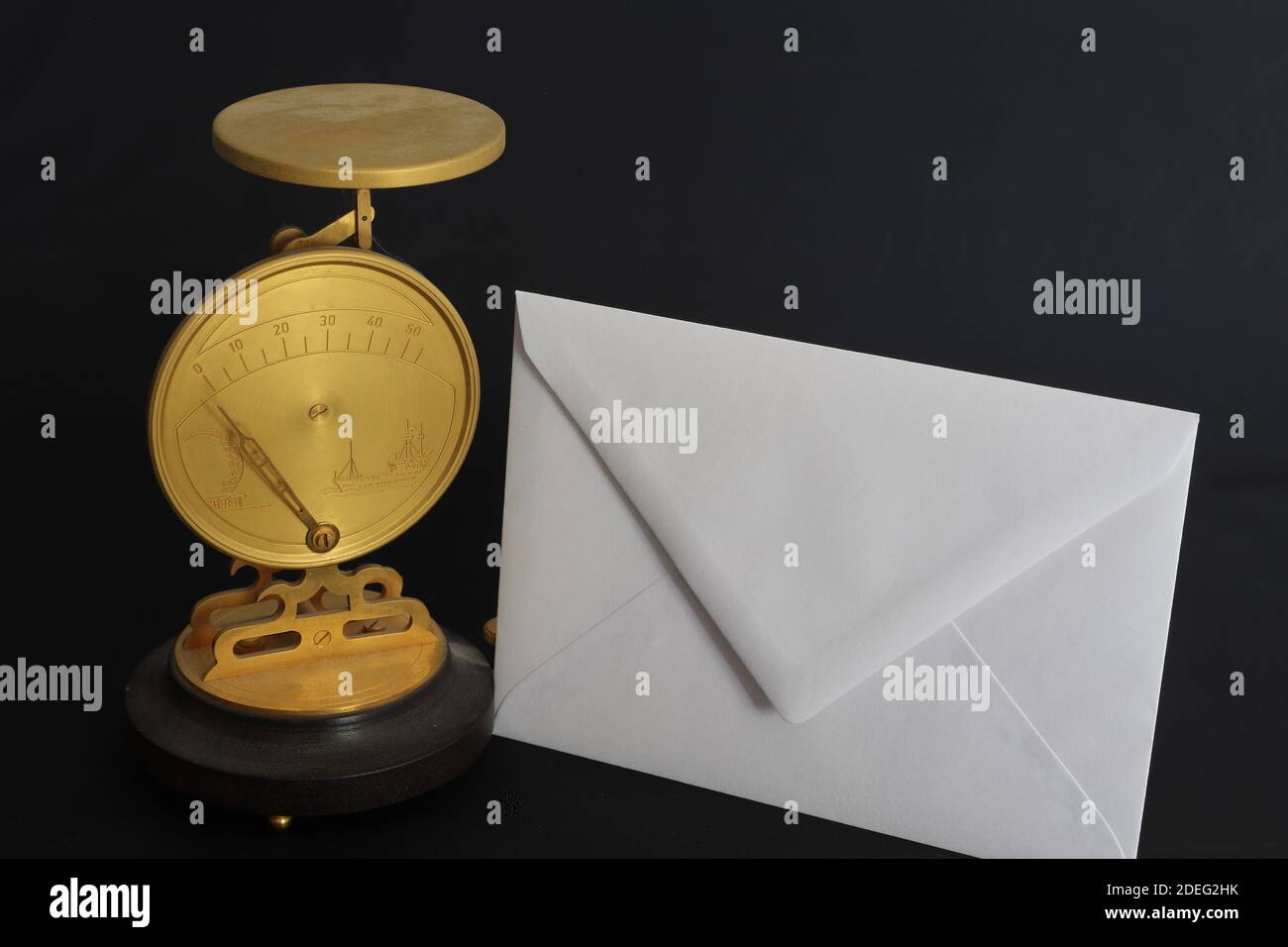 classic letter scale and white envelope Stock Photo