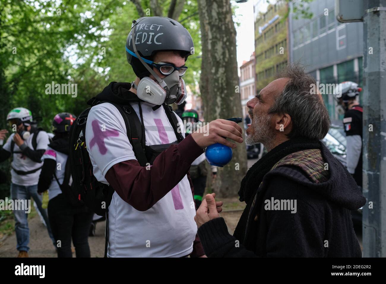 Street Medic treating a person after teargas fire. For the 24th consecutive  Saturday, the Gilets Jaunes (Yellow Vests) demonstrated in the streets of  Toulouse (France), April 27, 2019. Photo by Patrick Batard /