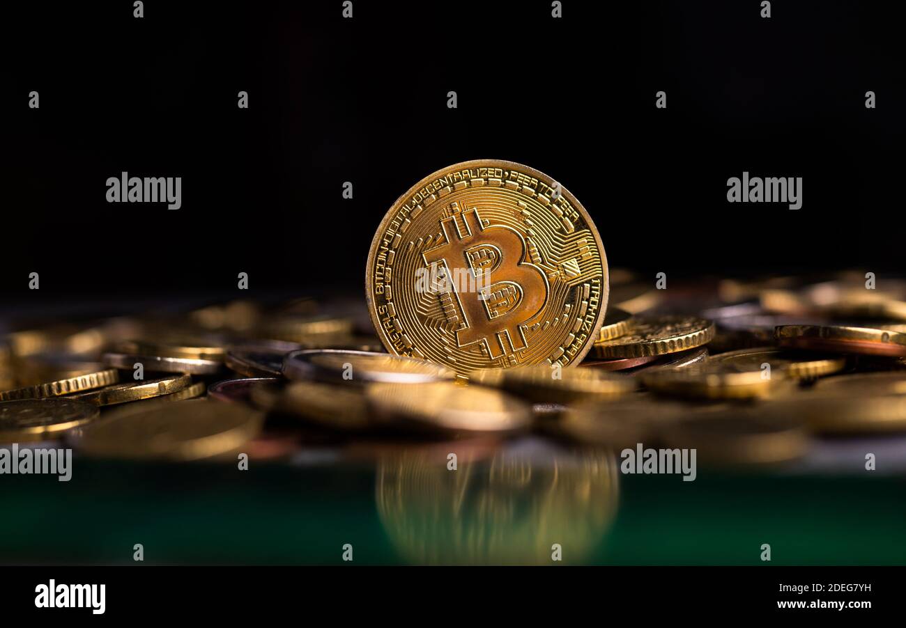 Bitcoin token on pile of euro coins Stock Photo