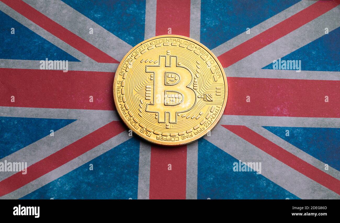 Bitcoin token on flag of the United Kingdom. Stock Photo