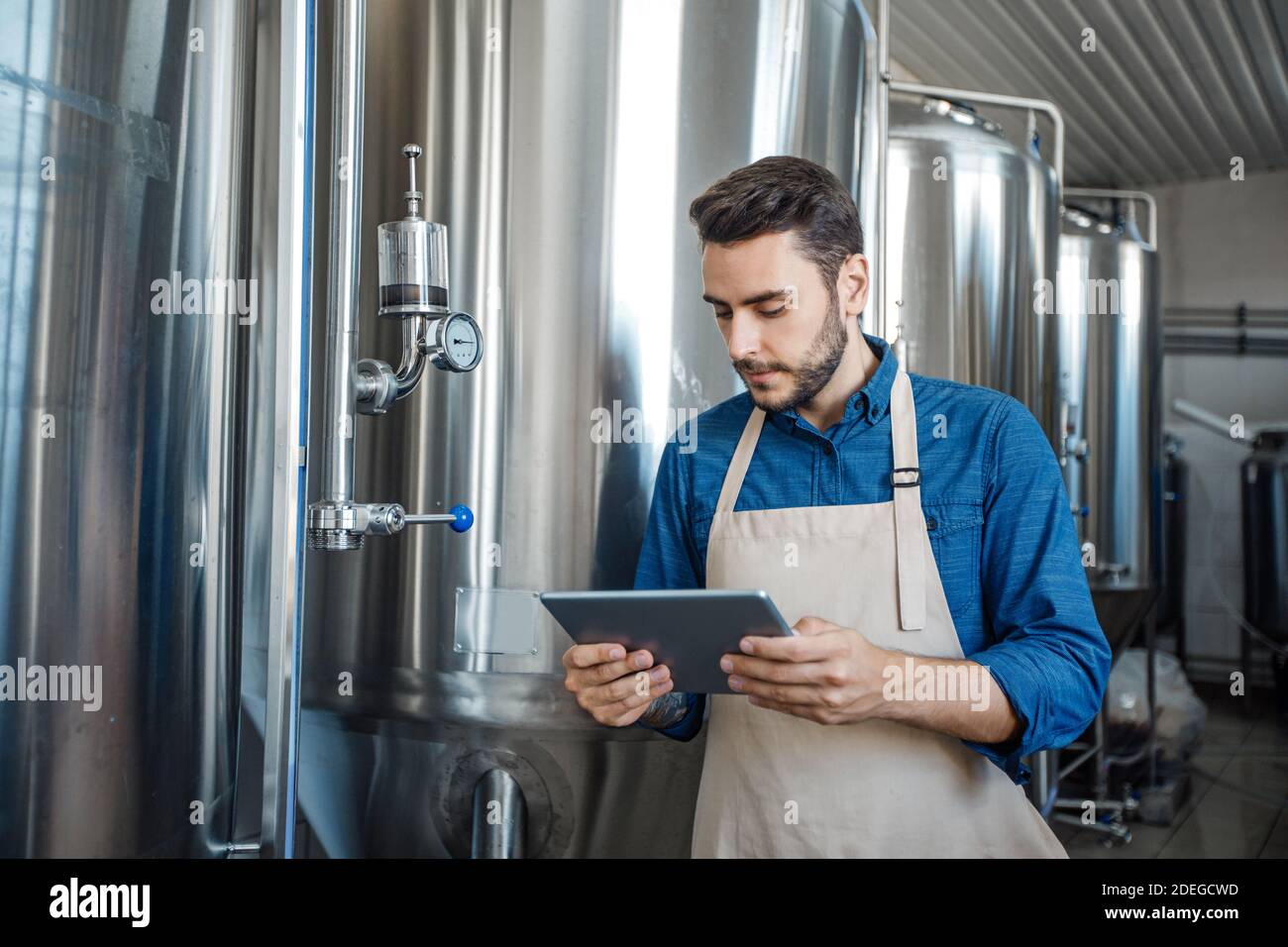 Modern gadgets, data collection and equipment control at brewery Stock Photo