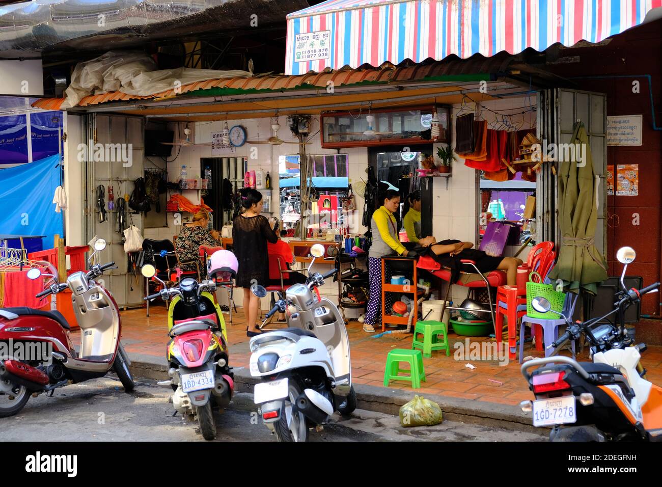 Cambodia Phnom Penh - Street photo with open barbershop in Downtown area Stock Photo