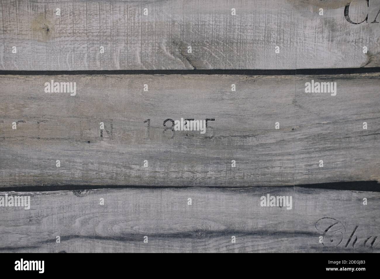 wooden texture of three planks with number 1855 embrassed on it Stock Photo