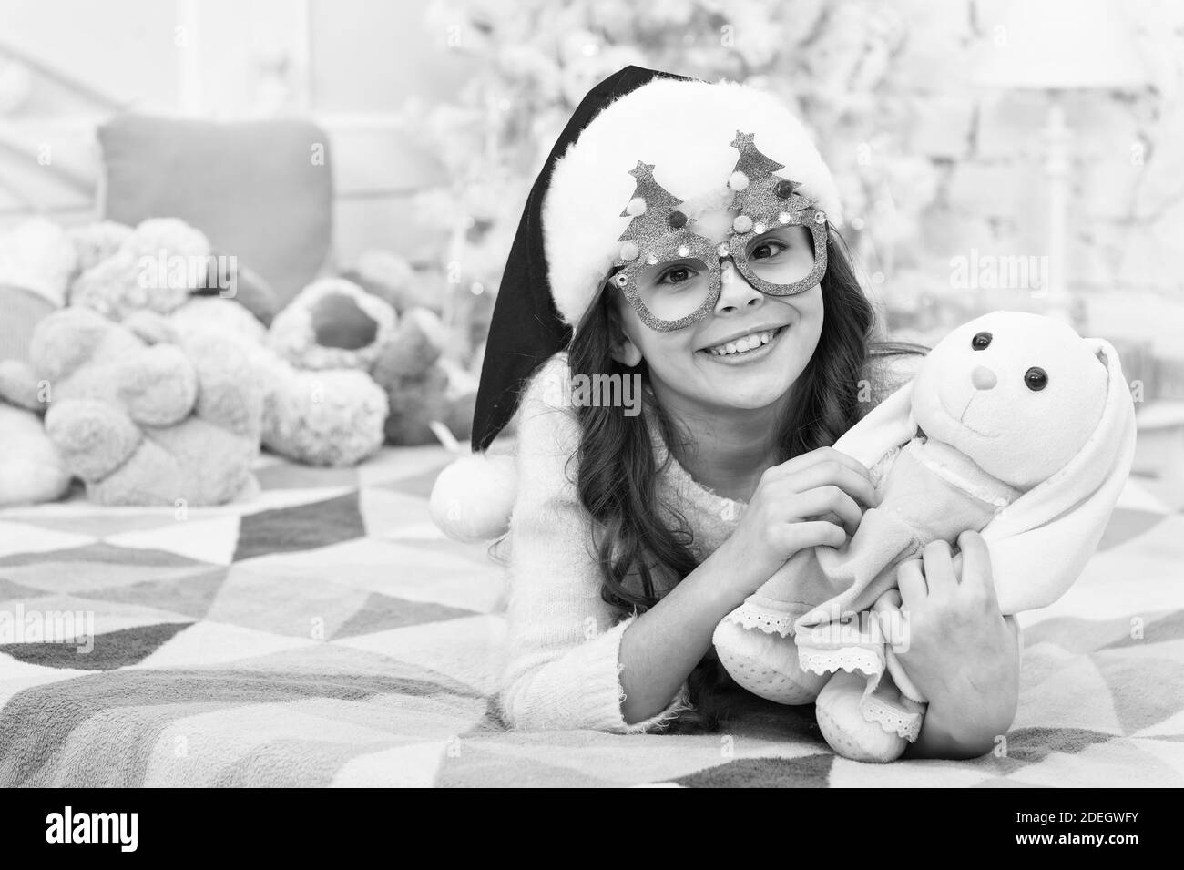 Winter holidays. Kid relaxing in bedroom. Adorable little girl wear