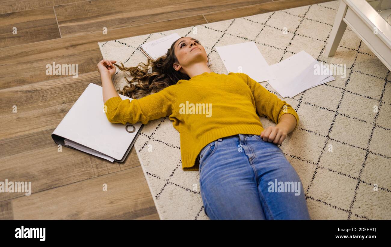 Young woman exhausted from work lying on the floor Stock Photo Alamy