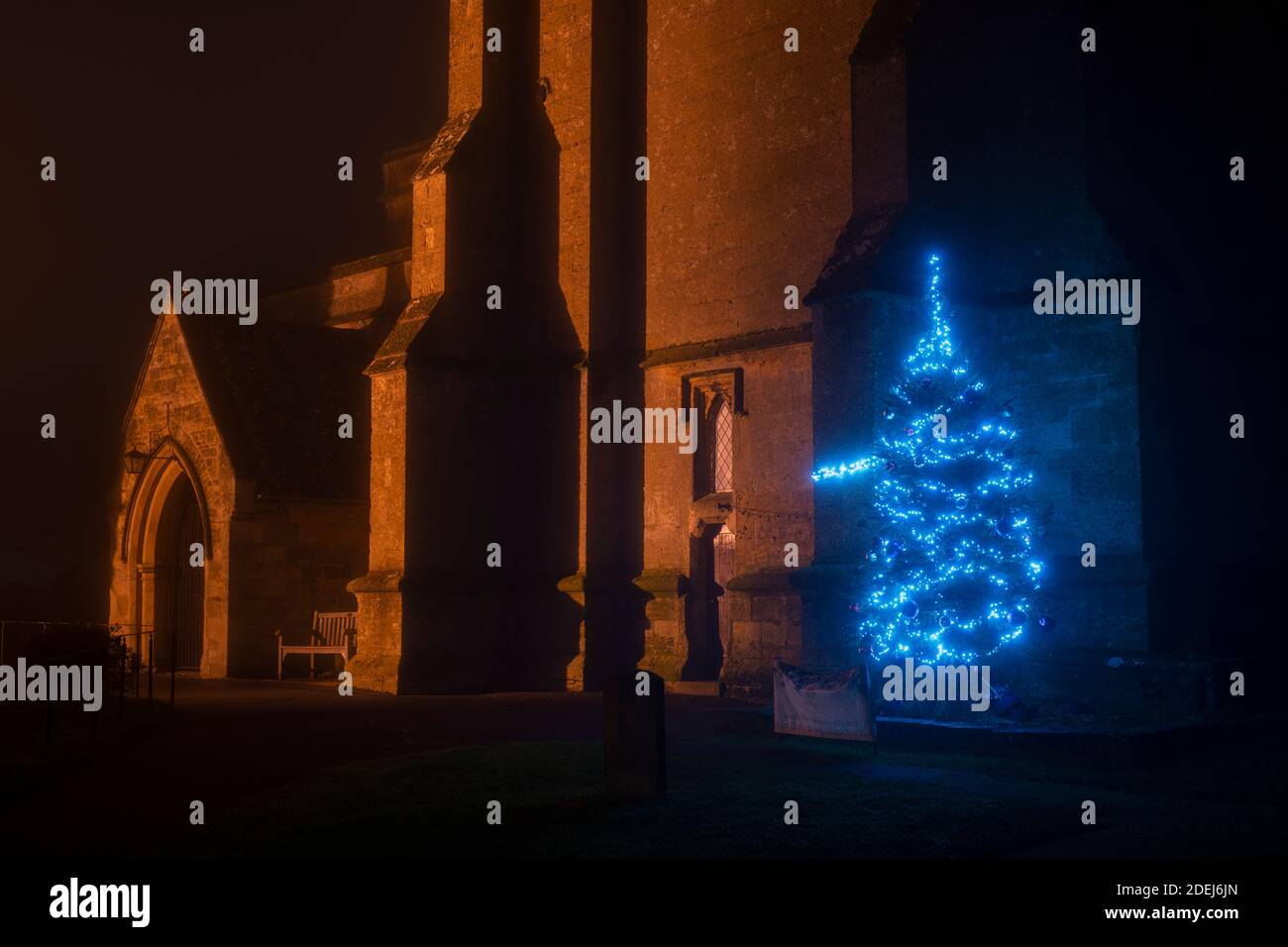 St Edwards church gates and christmas tree lights in the mist at night