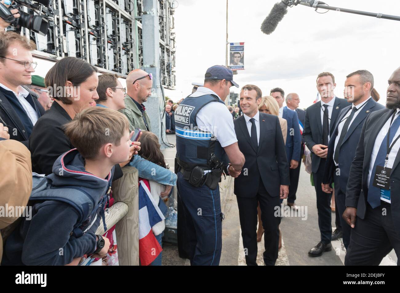 Emmanuel Macron shakes hands attending a ceremony to pay homage to the ...