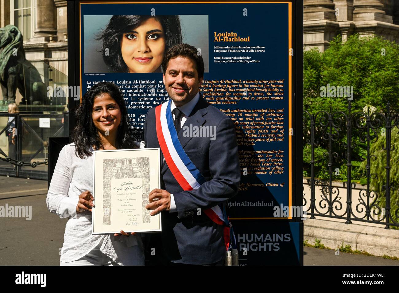 L-R : Lina Al Hathloul with honorary citizenship for her sister, jailed Saudi activist Loujain Al Hathloul and Paris Mayor Deputy Patrick Klugman pose next to a portrait of the jailed activist, near Hotel de Ville or City Hall, in Paris, France on June 21, 2019. Photo by Balkis Press/ABACAPRESS.COM Stock Photo