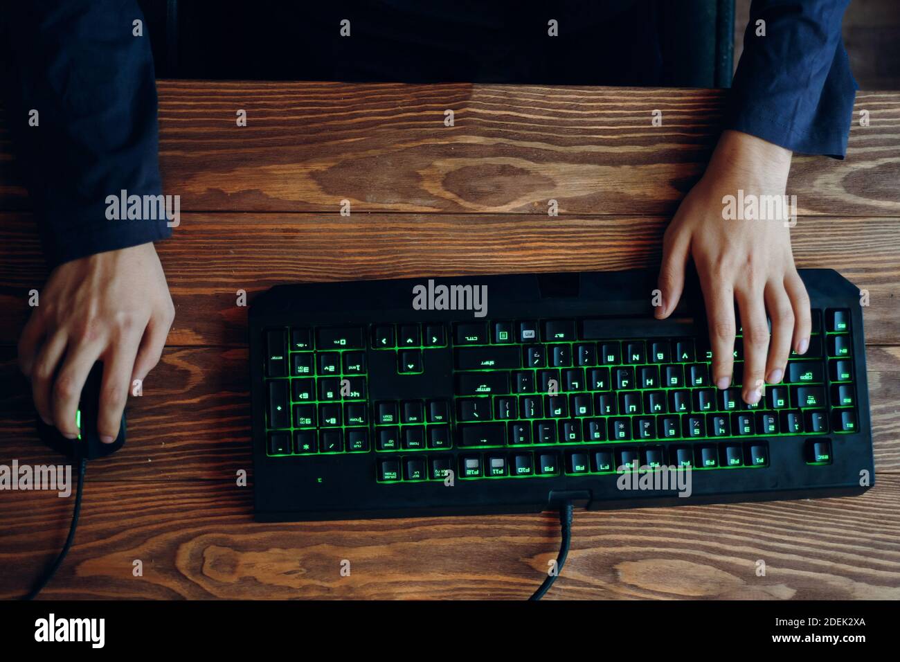 Gaming keyboard with neon lighting. Computer set. Hand typing on ...