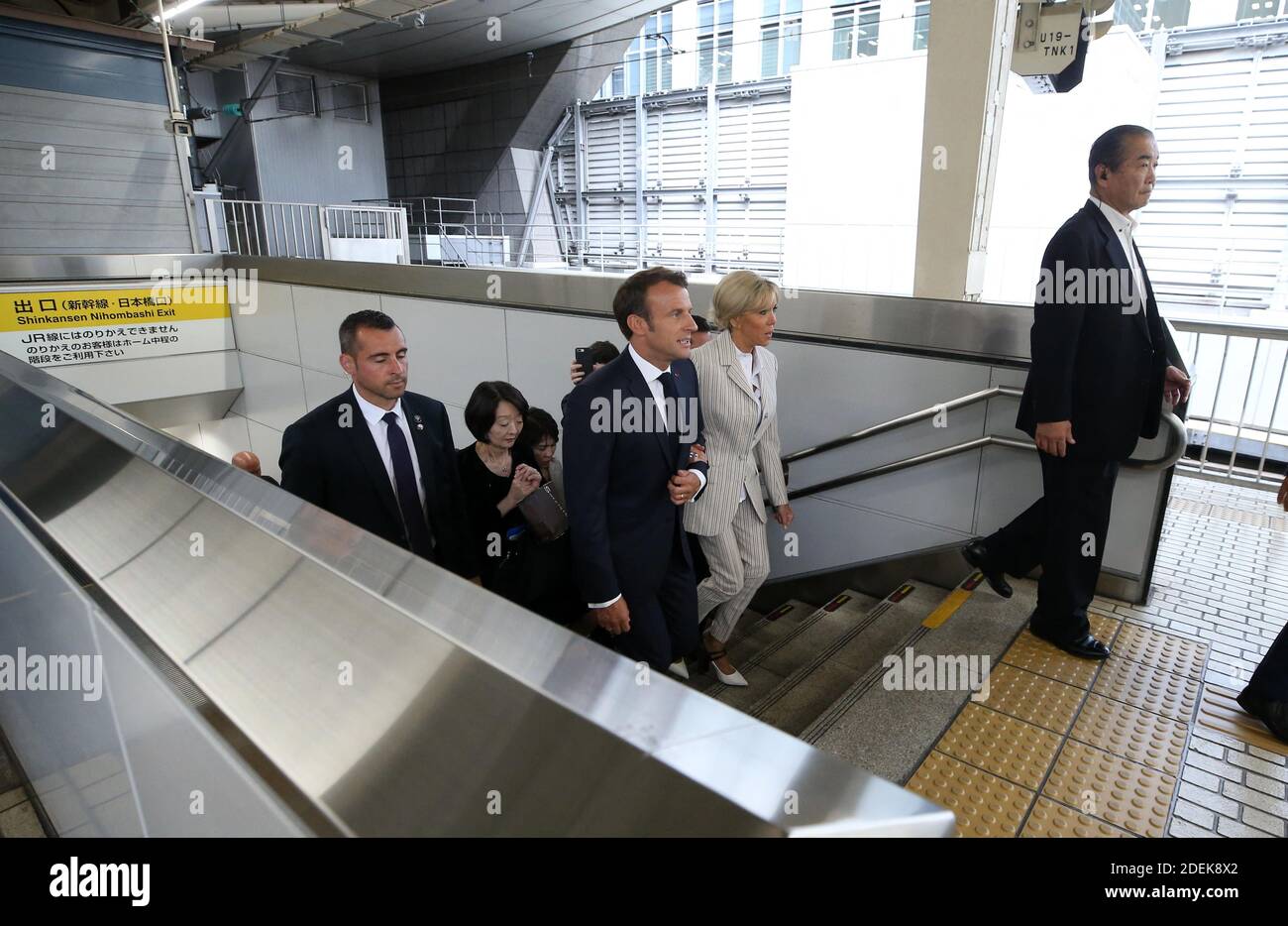 French President Emmanuel Macron and his wife Brigitte Macron walking