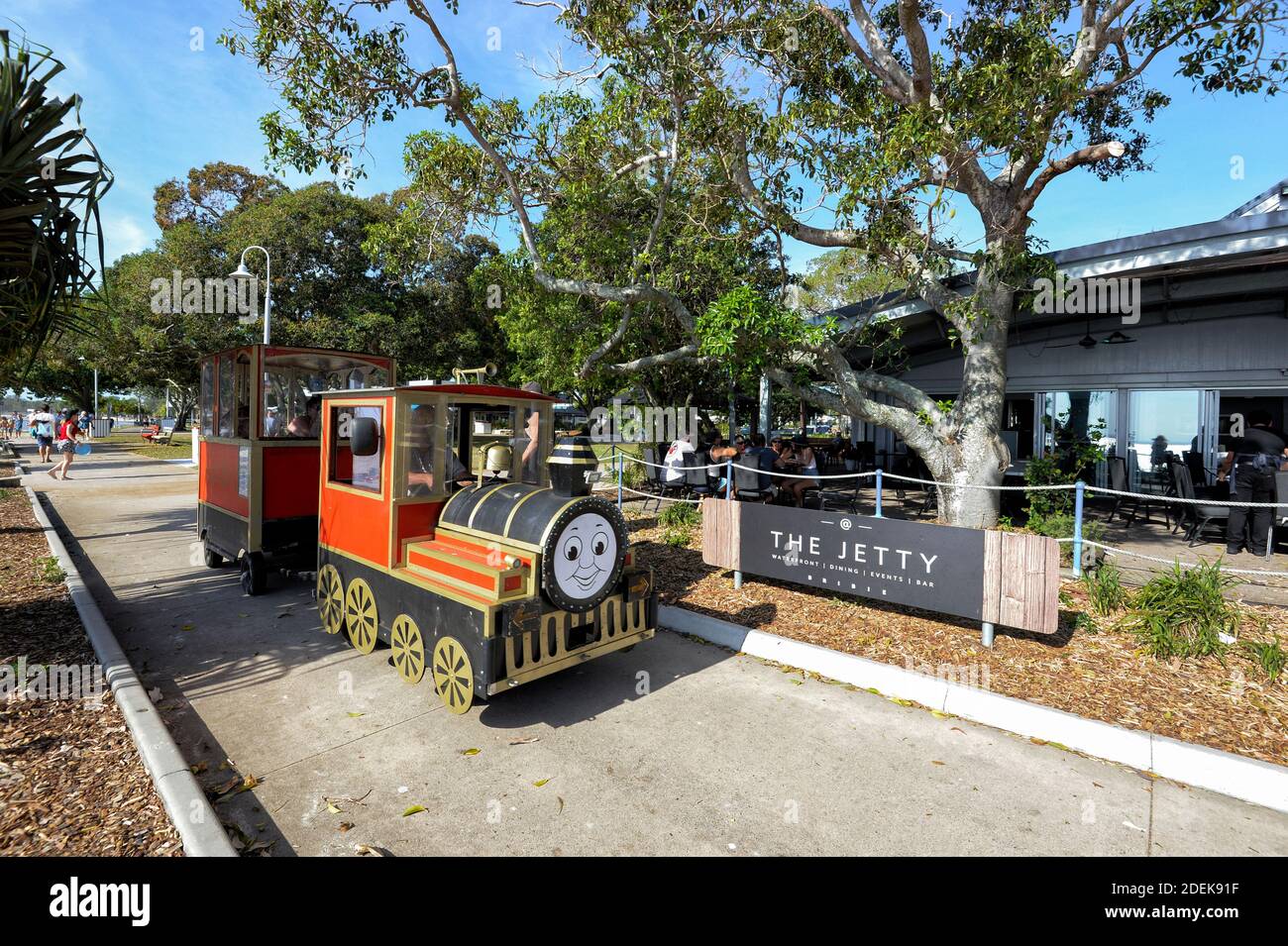 Children's Thomas the Tank Engine train ride in front of the Jetty Restaurant on the parade seafront, Bongaree, Bribie Island, Sunshine Coast, Queensl Stock Photo