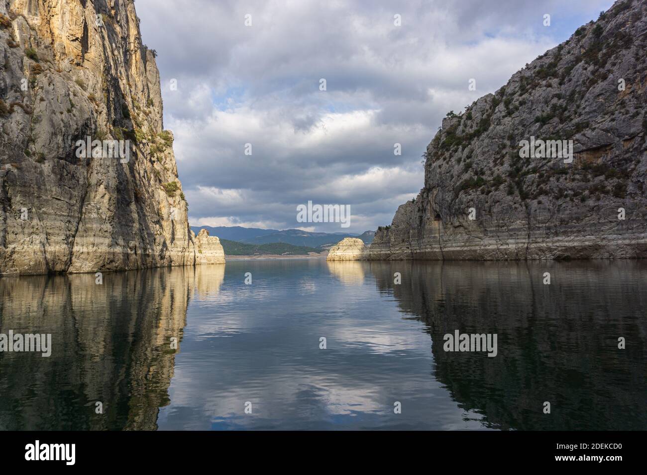 Reflection of rocks in water on a cloudy day Stock Photo